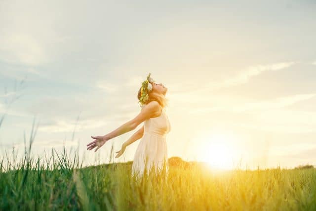 Freedom concept : Young beautiful woman enjoying with fresh air at meadows